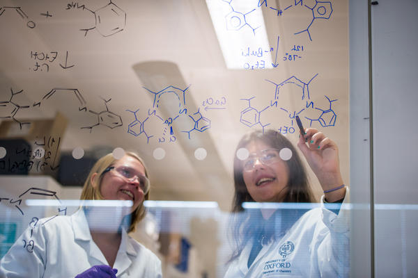 students labcoats writing
